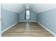 Finished attic bedroom features wood-look floors, a ceiling fan and fresh paint at 5096 Capulet Circle, Myrtle Beach, SC 29588
