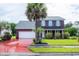 Charming two-story brick home with a well-manicured lawn and mature palm trees at 5096 Capulet Circle, Myrtle Beach, SC 29588