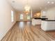 Open living space with wood-look floors that connects to a kitchen at 5096 Capulet Circle, Myrtle Beach, SC 29588