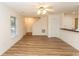 Open-concept living area with wood-look floors leading to the kitchen and staircase at 5096 Capulet Circle, Myrtle Beach, SC 29588