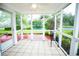 Bright sunroom with a tiled floor and views of the backyard pond at 5096 Capulet Circle, Myrtle Beach, SC 29588