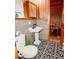 This bathroom showcases a black and white patterned floor and classic pedestal sink at 514 Blockade Dr., Pawleys Island, SC 29585