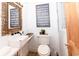 Cozy half bathroom with unique mirror and coastal themed wall art at 514 Blockade Dr., Pawleys Island, SC 29585