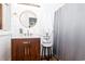 Stylish bathroom featuring a modern vanity, round mirror, and grey shower curtain at 514 Blockade Dr., Pawleys Island, SC 29585