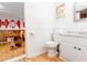 Well-lit bathroom with wainscoting, featuring a toilet, vanity, and sink at 514 Blockade Dr., Pawleys Island, SC 29585