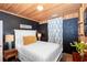 Cozy bedroom with hardwood floors, wood paneled ceiling, and a comfortable queen-sized bed at 514 Blockade Dr., Pawleys Island, SC 29585