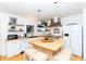 Modern kitchen with butcher block island, pendant lighting, and stainless steel appliances at 514 Blockade Dr., Pawleys Island, SC 29585