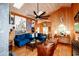 Spacious living room with wood paneled walls, vaulted ceiling and a cozy blue sofa at 514 Blockade Dr., Pawleys Island, SC 29585