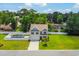 Aerial view of home with a sparkling pool, lush lawn, and inviting curb appeal at 547 Pacific Commons Dr., Surfside Beach, SC 29575