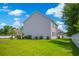 Spacious backyard with lawn and a white vinyl fence at 547 Pacific Commons Dr., Surfside Beach, SC 29575