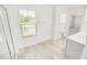 Well-lit bathroom featuring tile flooring, a window, and a sleek vanity with modern fixtures at 547 Pacific Commons Dr., Surfside Beach, SC 29575
