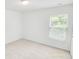 A bright bedroom featuring neutral carpet and a window with natural light at 547 Pacific Commons Dr., Surfside Beach, SC 29575