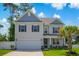 Charming two-story home featuring a two-car garage, manicured lawn, and inviting entrance at 547 Pacific Commons Dr., Surfside Beach, SC 29575