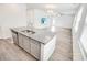 Open kitchen with granite counters, an island, and stainless steel appliances with views to the living area at 547 Pacific Commons Dr., Surfside Beach, SC 29575