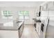 Bright kitchen featuring an island with a granite countertop and stainless steel appliances at 547 Pacific Commons Dr., Surfside Beach, SC 29575