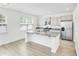 Bright, open kitchen features a large island with granite countertops and stainless steel appliances at 547 Pacific Commons Dr., Surfside Beach, SC 29575