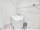 Bright laundry room with white washer, dryer and storage shelving for convenience at 547 Pacific Commons Dr., Surfside Beach, SC 29575