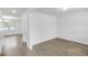 Bright and spacious living room with light-colored floors and neutral walls, leading to other rooms at 547 Pacific Commons Dr., Surfside Beach, SC 29575