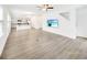 Open-concept living space featuring light wood flooring, a TV, and seamlessly flowing into the kitchen area at 547 Pacific Commons Dr., Surfside Beach, SC 29575