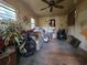 Living room showing hardwood floors, a ceiling fan, and multiple windows providing ample natural light at 564 Baker Ave., Murrells Inlet, SC 29576