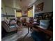 Room features hardwood floors, space for a couch, and a desk in need of tidying up at 564 Baker Ave., Murrells Inlet, SC 29576