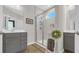 A tiled shower, gray cabinets and wood-look floors make this bathroom a delight at 598 Cascade Loop, Little River, SC 29566