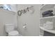 This bathroom is simple with its white toilet and wicker storage at 598 Cascade Loop, Little River, SC 29566
