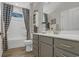 Gray cabinets and a white shower surround finish the look in this bathroom at 598 Cascade Loop, Little River, SC 29566