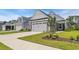 View of a well-kept lawn and manicured landscaping leading up to the charming home at 598 Cascade Loop, Little River, SC 29566
