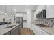 Well-equipped kitchen featuring white cabinetry and modern stainless steel appliances at 598 Cascade Loop, Little River, SC 29566