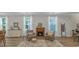Cozy living room with a fireplace, accent chairs, and natural light at 598 Cascade Loop, Little River, SC 29566