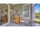 A peaceful back porch space with potting table and seating provides a relaxing spot at 598 Cascade Loop, Little River, SC 29566
