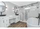 Beautiful primary bath with soaking tub, glass shower, double vanities and wood look floors at 6001- Q10 S Kings Hwy., Myrtle Beach, SC 29575