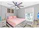 Bright bedroom featuring a full bed, ceiling fan, and large window at 6001- Q10 S Kings Hwy., Myrtle Beach, SC 29575