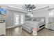 Stylish bedroom with a ceiling fan, private patio, and light gray color palette at 6001- Q10 S Kings Hwy., Myrtle Beach, SC 29575
