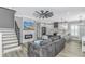 Open living area with a fireplace, TV, ceiling fan, and modern kitchen with white cabinetry at 6001- Q10 S Kings Hwy., Myrtle Beach, SC 29575