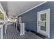 Covered porch features exterior door, ceiling fan, composite decking, and white railing at 6001- Q10 S Kings Hwy., Myrtle Beach, SC 29575