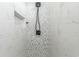 Close up of a shower with white marble tile, mosaic floor and black fixtures at 6001- Q10 S Kings Hwy., Myrtle Beach, SC 29575