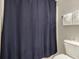 Full bathroom with toilet, dark blue shower curtain and fluffy white towels on a rack at 6015 Catalina Dr. # 634, North Myrtle Beach, SC 29582