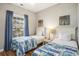 Cozy bedroom with two twin beds, hardwood floors, and coastal-themed artwork at 6015 Catalina Dr. # 634, North Myrtle Beach, SC 29582