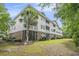 Attractive condo building featuring screened porches, balconies, and lush landscaping at 6015 Catalina Dr. # 634, North Myrtle Beach, SC 29582