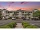Three-story condo with white balconies, palm trees, and well-maintained landscaping against a vibrant sunset sky at 6015 Catalina Dr. # 634, North Myrtle Beach, SC 29582