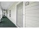 Condo entrance featuring green carpet, neutral walls, and clear unit number signage at 6015 Catalina Dr. # 634, North Myrtle Beach, SC 29582