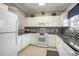 Clean kitchen featuring white cabinets, tile backsplash, and modern appliances at 6015 Catalina Dr. # 634, North Myrtle Beach, SC 29582