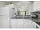 Cozy kitchen with granite countertops, mosaic backsplash, and white cabinets at 6015 Catalina Dr. # 634, North Myrtle Beach, SC 29582