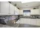 Bright kitchen featuring white cabinets, granite countertops, and modern appliances at 6015 Catalina Dr. # 634, North Myrtle Beach, SC 29582
