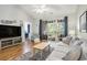 Open-concept living room with hardwood floors, access to a balcony, and a view into the bedroom at 6015 Catalina Dr. # 634, North Myrtle Beach, SC 29582