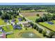 Wide aerial shot of a residential area showcasing various houses and surrounding streets and wooded areas at 605 Fieldwoods Dr., Conway, SC 29526