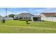 Well-manicured backyard with green lawn, patio area and tasteful landscaping, perfect for outdoor entertaining at 605 Fieldwoods Dr., Conway, SC 29526
