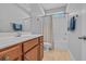 Well-lit bathroom with wood cabinets, shower, and well maintained fixtures at 605 Fieldwoods Dr., Conway, SC 29526